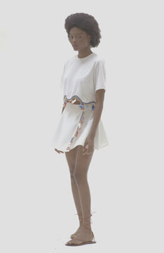 video of White terycloth crop top with crocheted fish and lifesaver motifs at hem
