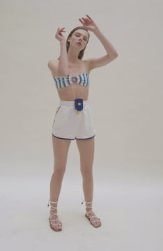 video of white french terrycloth shorts with blue trim