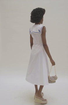 video of White dress with blue fish details at collar and crochet buttons