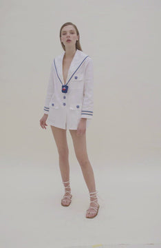 Video showing oversized white nautical blazer with blue trim and buttons