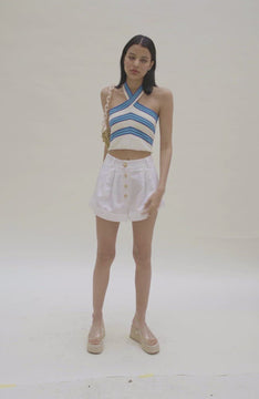 Video of Front view white cuffed pleated shorts with buttons